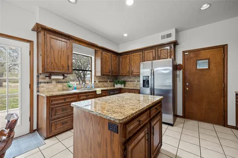 a kitchen with a stove a refrigerator and a sink