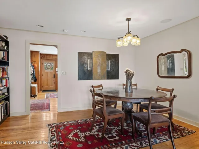 a view of a dining room with furniture and chandelier