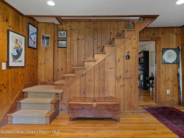 a view of entryway with stairs and a rug