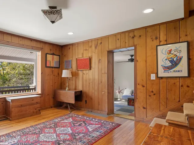 a living room with a couch and a dresser next to a window