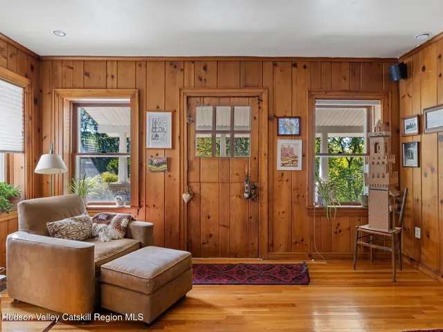 a living room with furniture and large windows