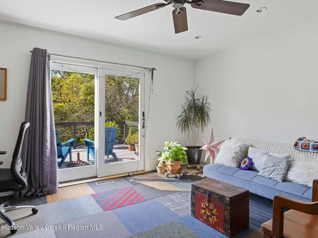 a living room with furniture and a floor to ceiling window