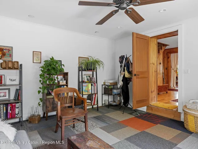 a view of a livingroom with workspace and a window