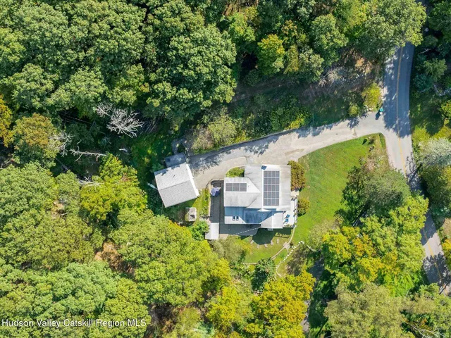 an aerial view of a house with a yard
