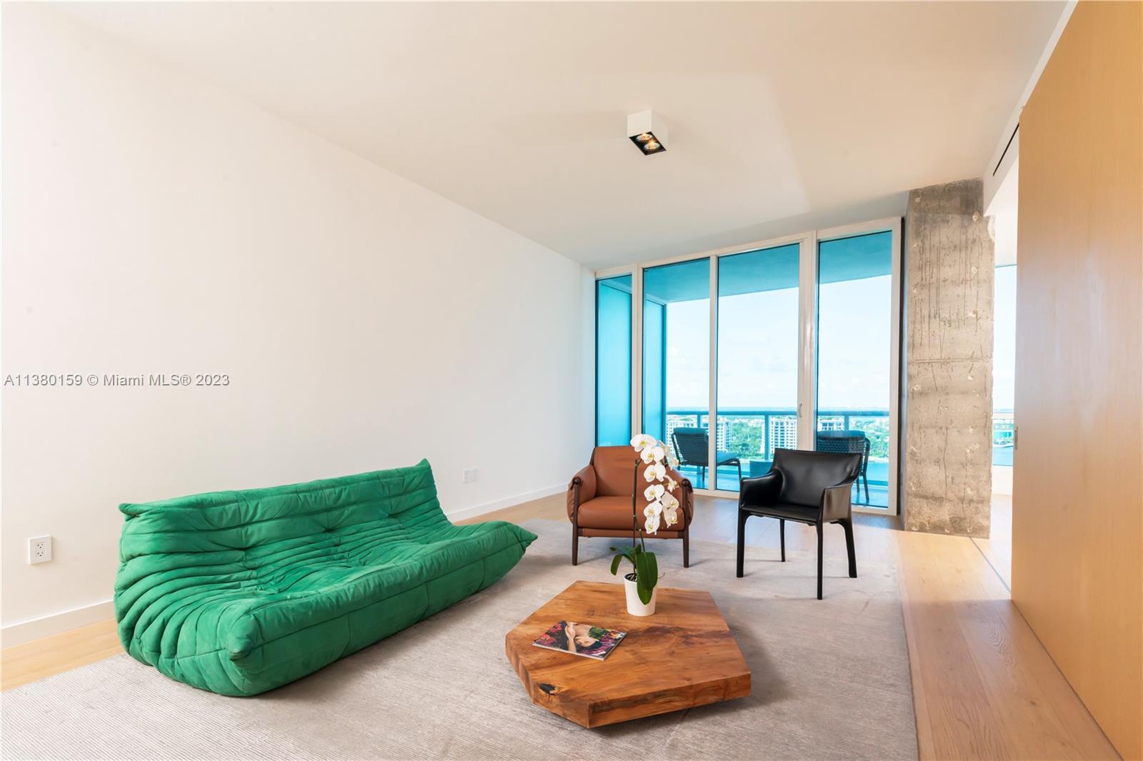 100 South Pointe Drive, Unit 1802 Miami Beach, FL 33139 - Photo 13 of 17 a living room with furniture and floor to ceiling window
