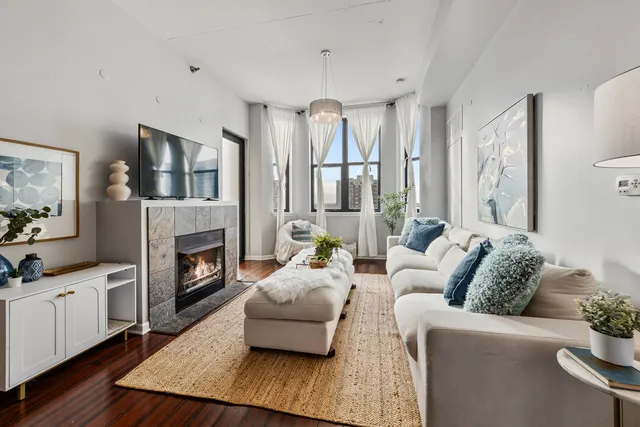 a living room with furniture fireplace and window