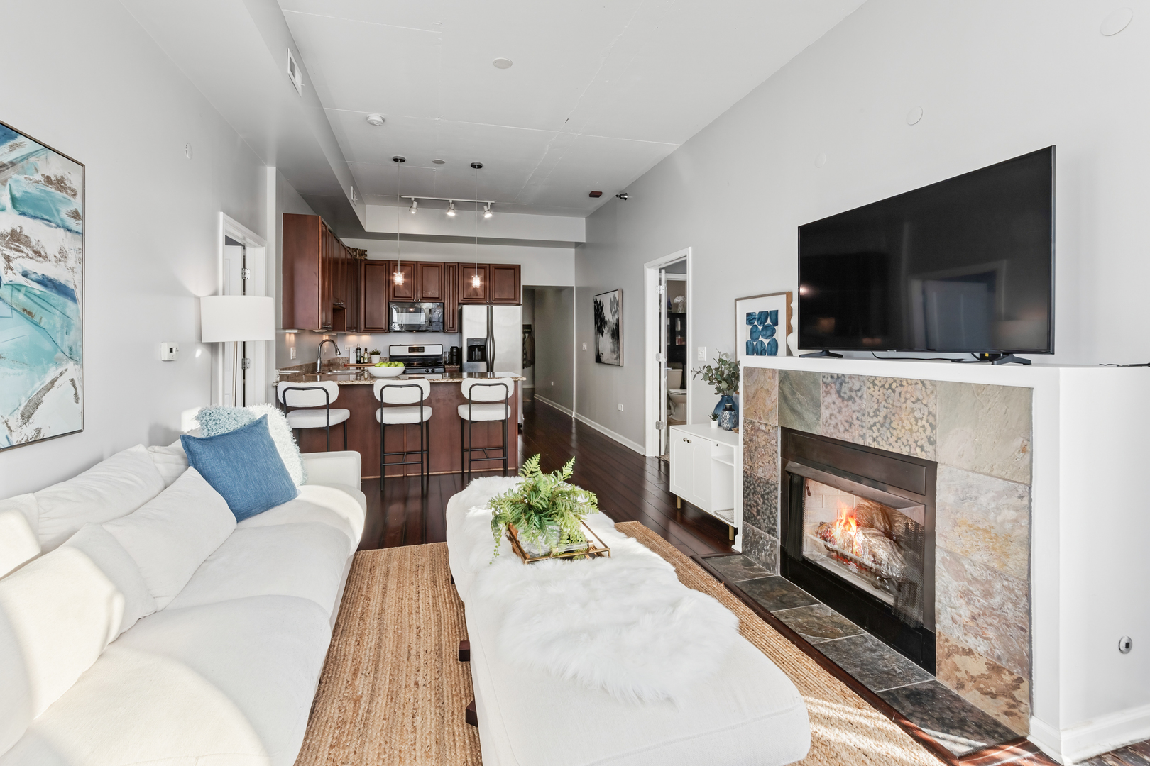 1464 South Michigan Avenue, Unit 1107 Chicago, IL 60605 - Photo 6 of 20 a living room with furniture a flat screen tv and a fireplace