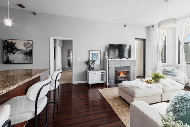 a living room with furniture fireplace and flat screen tv