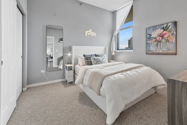 a bed room with a bed and a painting