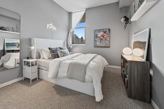 a bedroom with a bed and a flat tv screen