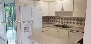 an empty room with windows & cabinet