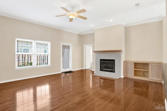 a view of an empty room with a fireplace and a window