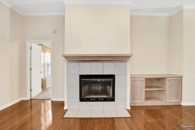 a living room with a fireplace and a wooden floor