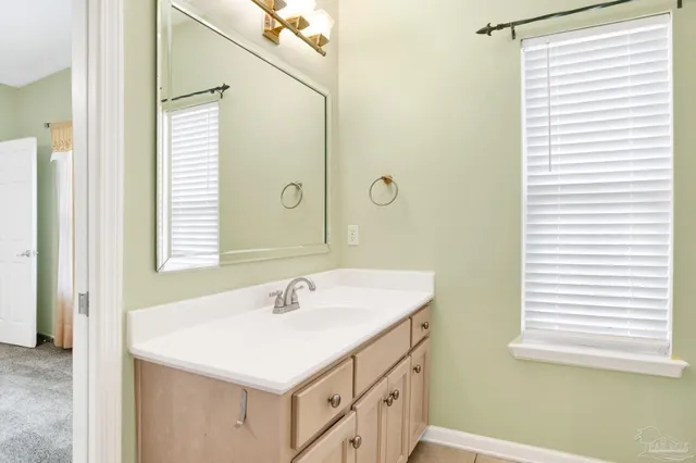 a bathroom with a sink vanity and a mirror