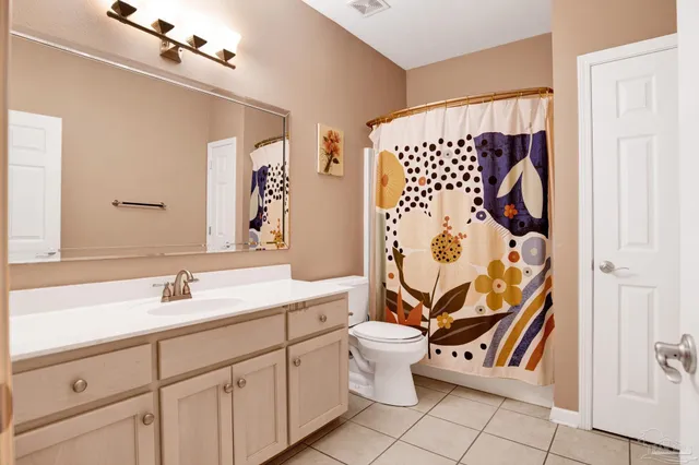 a bathroom with a sink and mirror with toilet