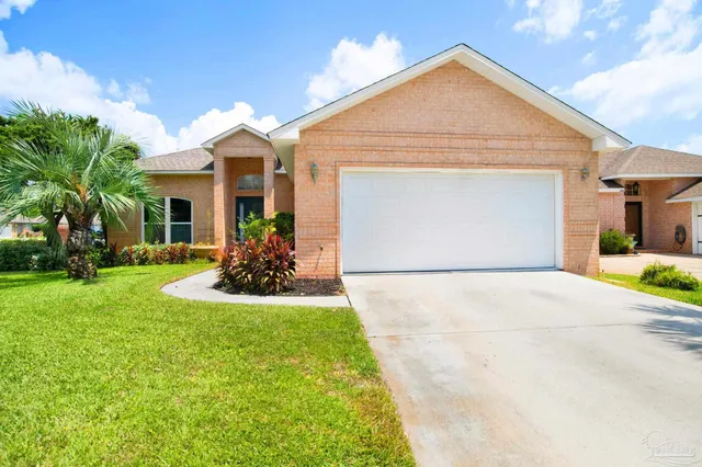 a front view of a house with a yard and porch