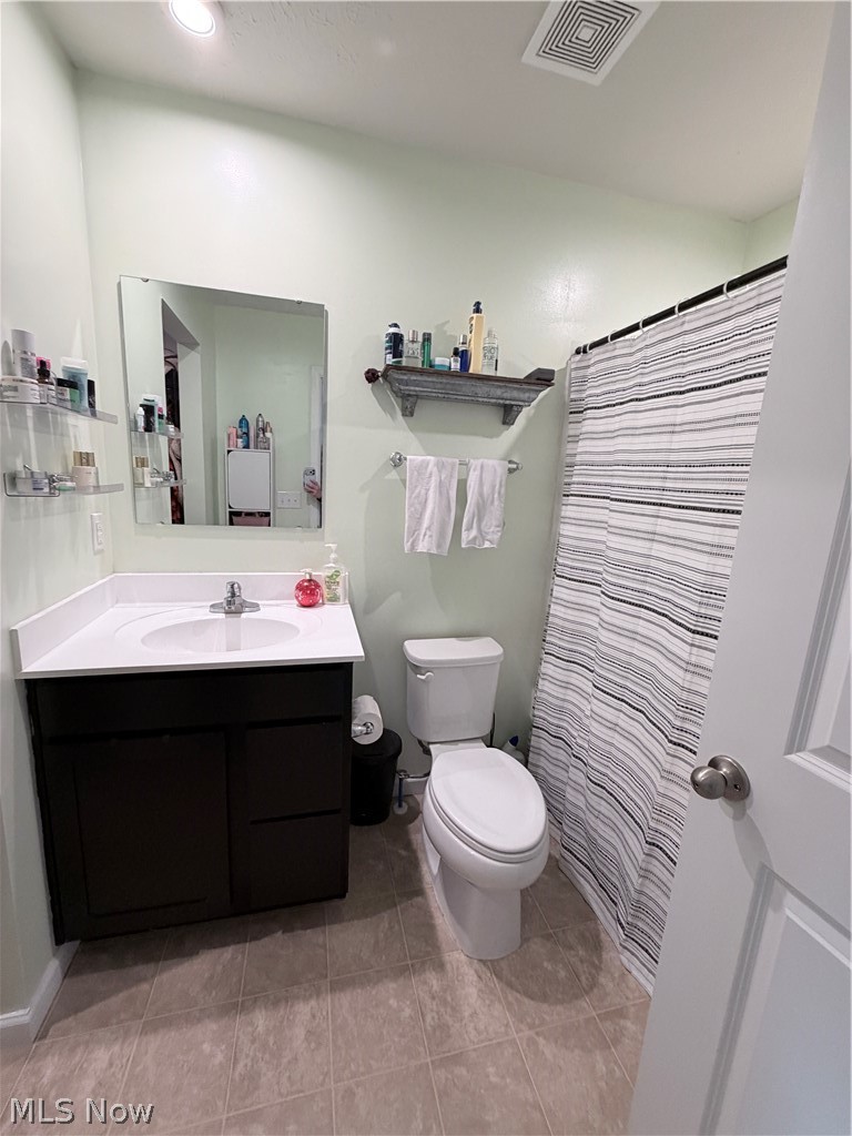 177 Raintree Lane Painesville, OH 44077 - Photo 17 of 40 Bathroom featuring vanity, curtained shower, and light tile patterned floors