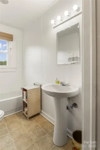 a bathroom with a sink a toilet and bathtub