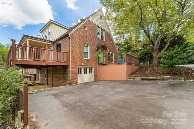 a view of a house with a yard and sitting area