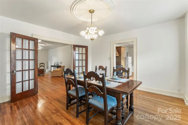 a view of a dining room with furniture and a chandelier