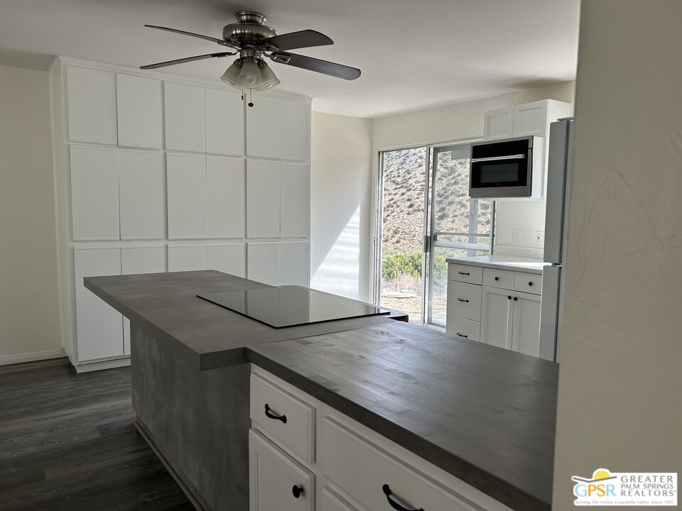 49760 Big Morongo Canyon Road Morongo Valley, CA 92256 - Photo 12 of 47 a kitchen with a sink a microwave and cabinets
