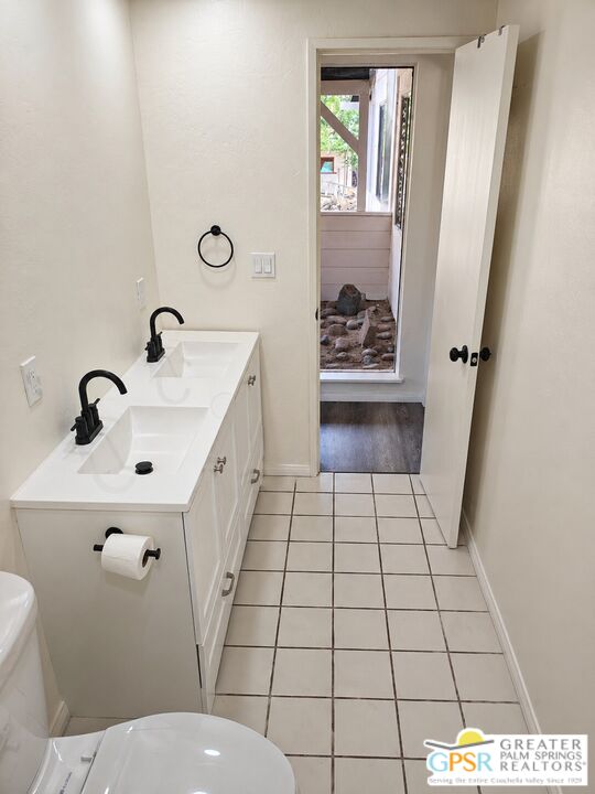 49760 Big Morongo Canyon Road Morongo Valley, CA 92256 - Photo 18 of 47 a bathroom with a sink a toilet and a mirror