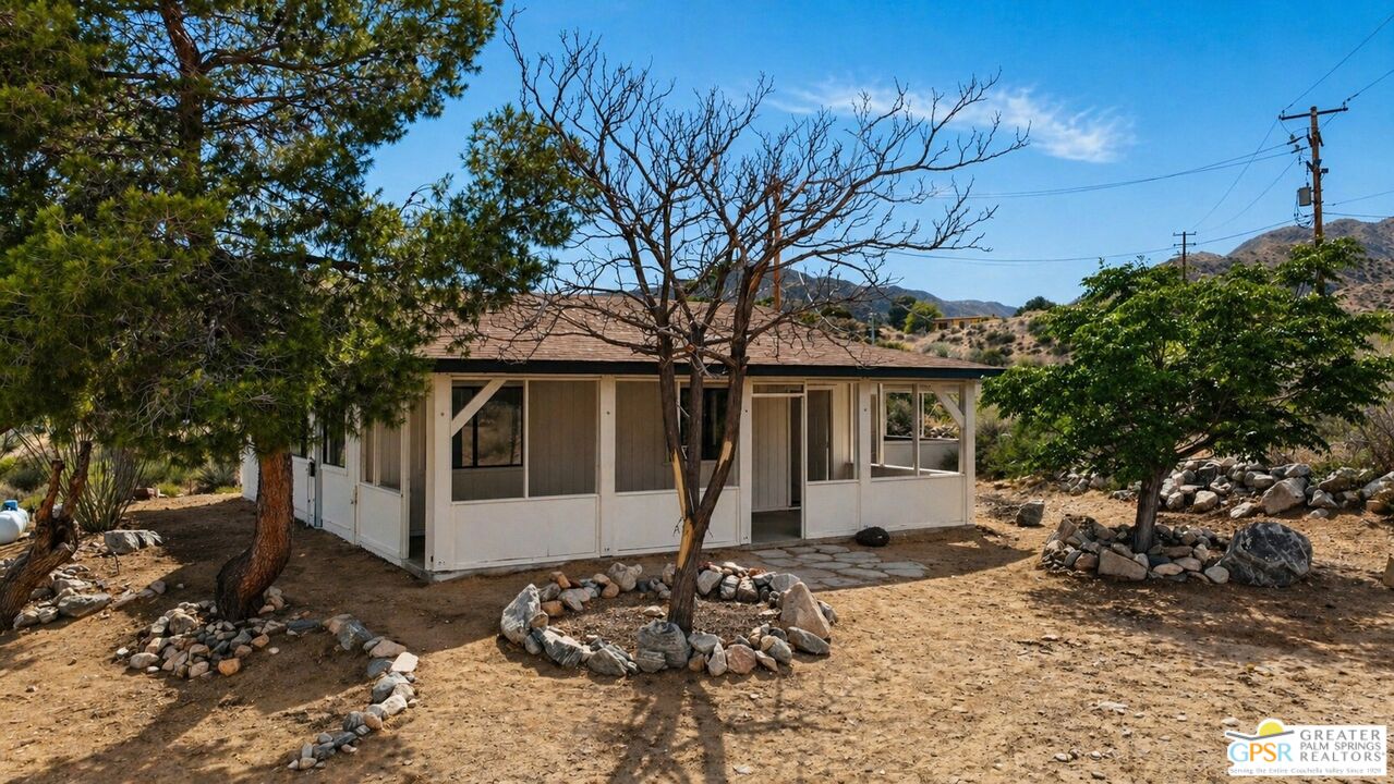 49760 Big Morongo Canyon Road Morongo Valley, CA 92256 - Photo 2 of 47 a front view of a house with a tree