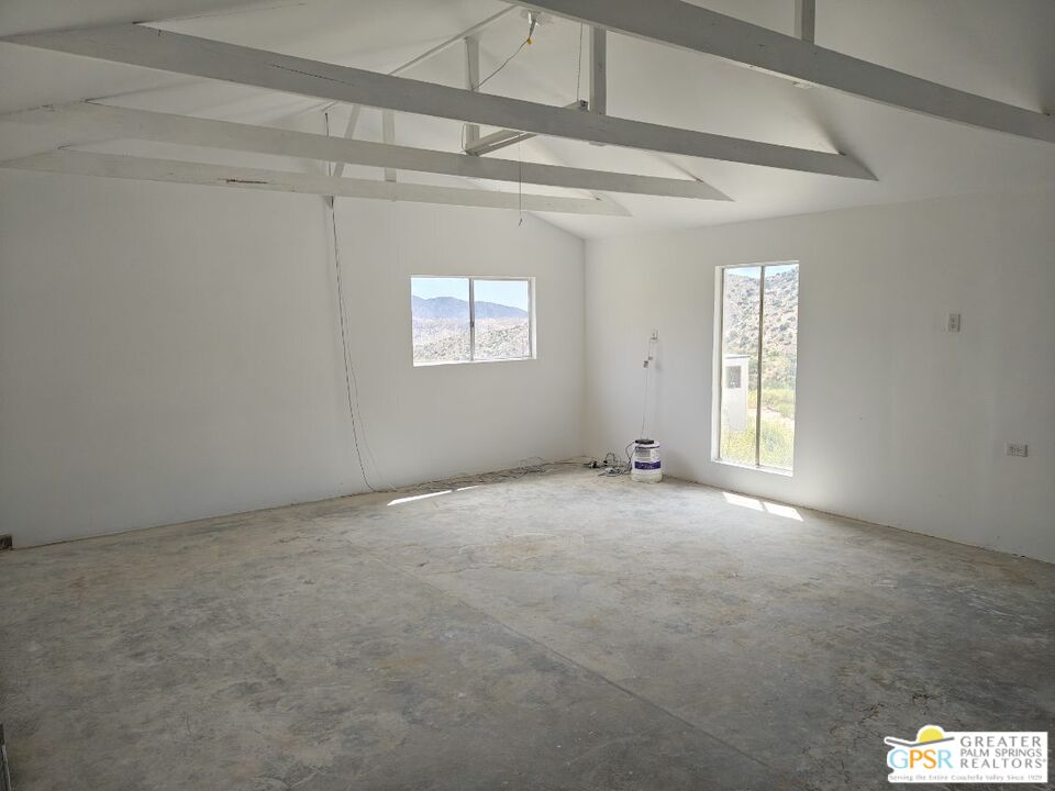 49760 Big Morongo Canyon Road Morongo Valley, CA 92256 - Photo 29 of 47 an empty room with windows and entrance