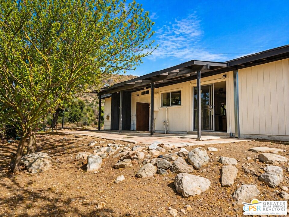 49760 Big Morongo Canyon Road Morongo Valley, CA 92256 - Photo 38 of 47 a front view of a house with a yard