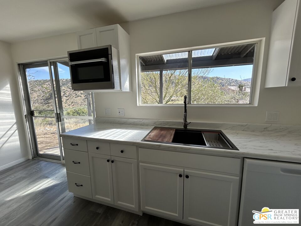 49760 Big Morongo Canyon Road Morongo Valley, CA 92256 - Photo 9 of 47 a kitchen with a sink window and cabinets