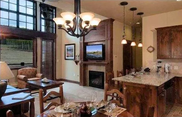 a living room with fireplace furniture and a chandelier