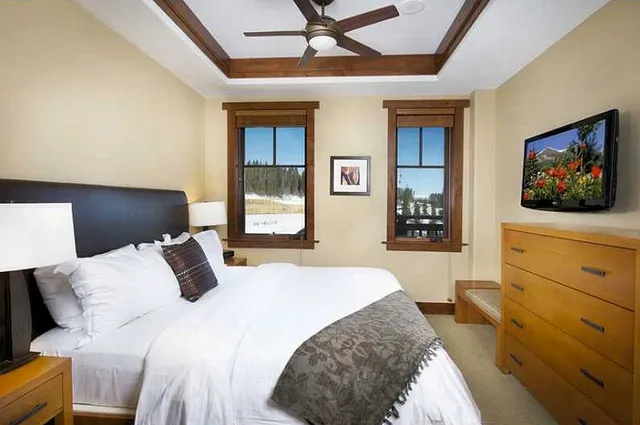 a bedroom with a bed and a flat screen tv