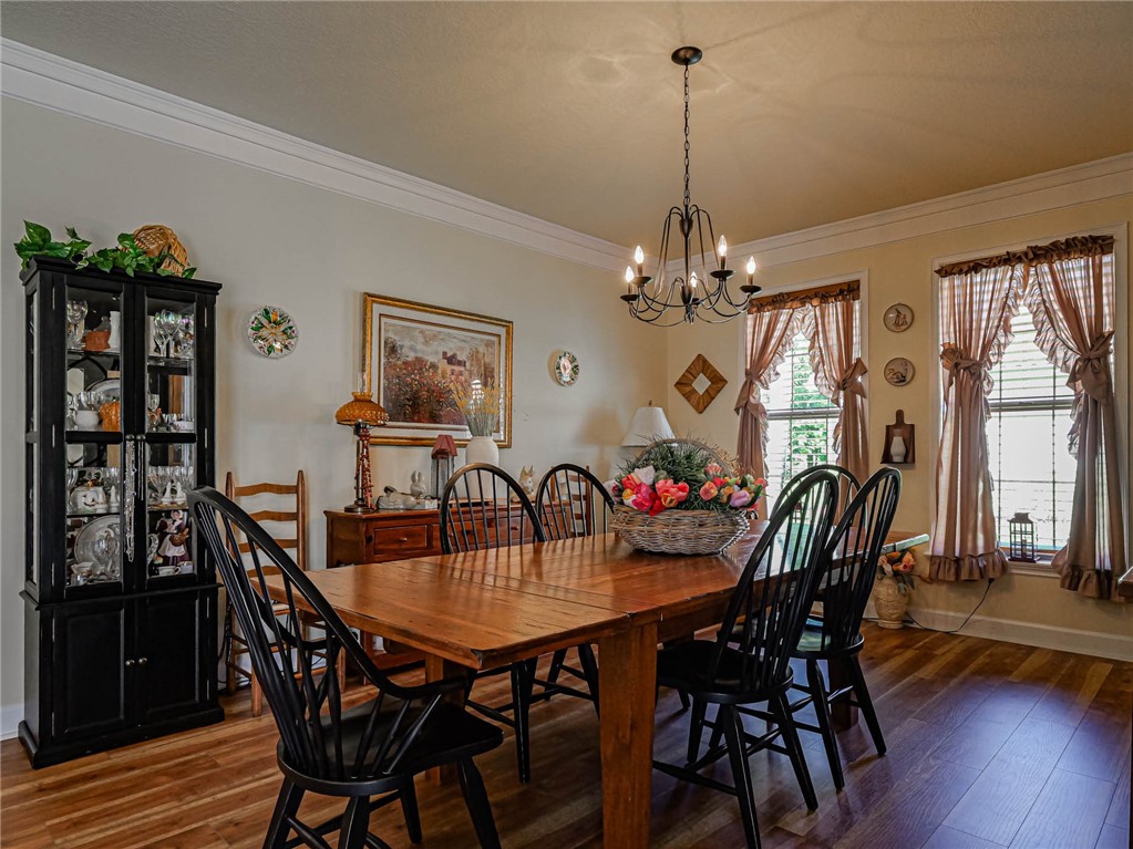 5824 Pine Ridge Circle Vero Beach, FL 32967 - Photo 13 of 34 a dining room with furniture a chandelier and wooden floor