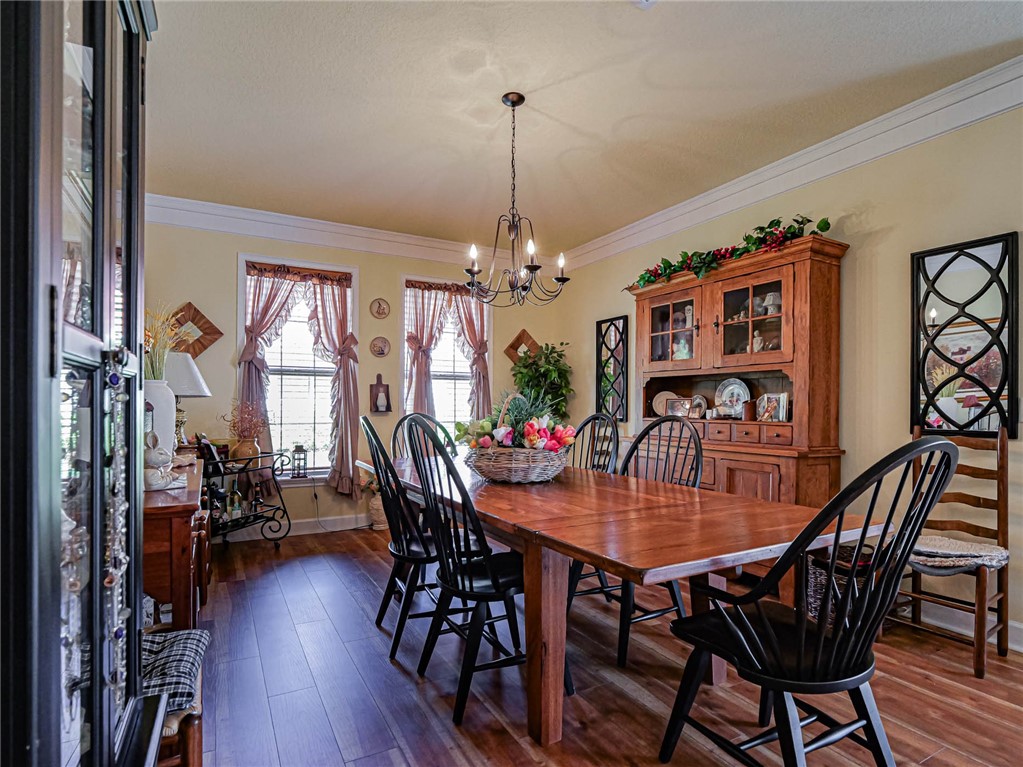 5824 Pine Ridge Circle Vero Beach, FL 32967 - Photo 14 of 34 a view of a dining room with furniture window and wooden floor