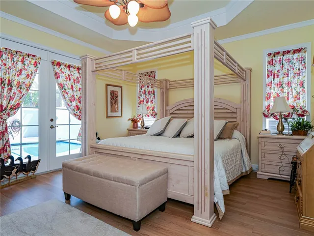 a bedroom with a bed and a chandelier
