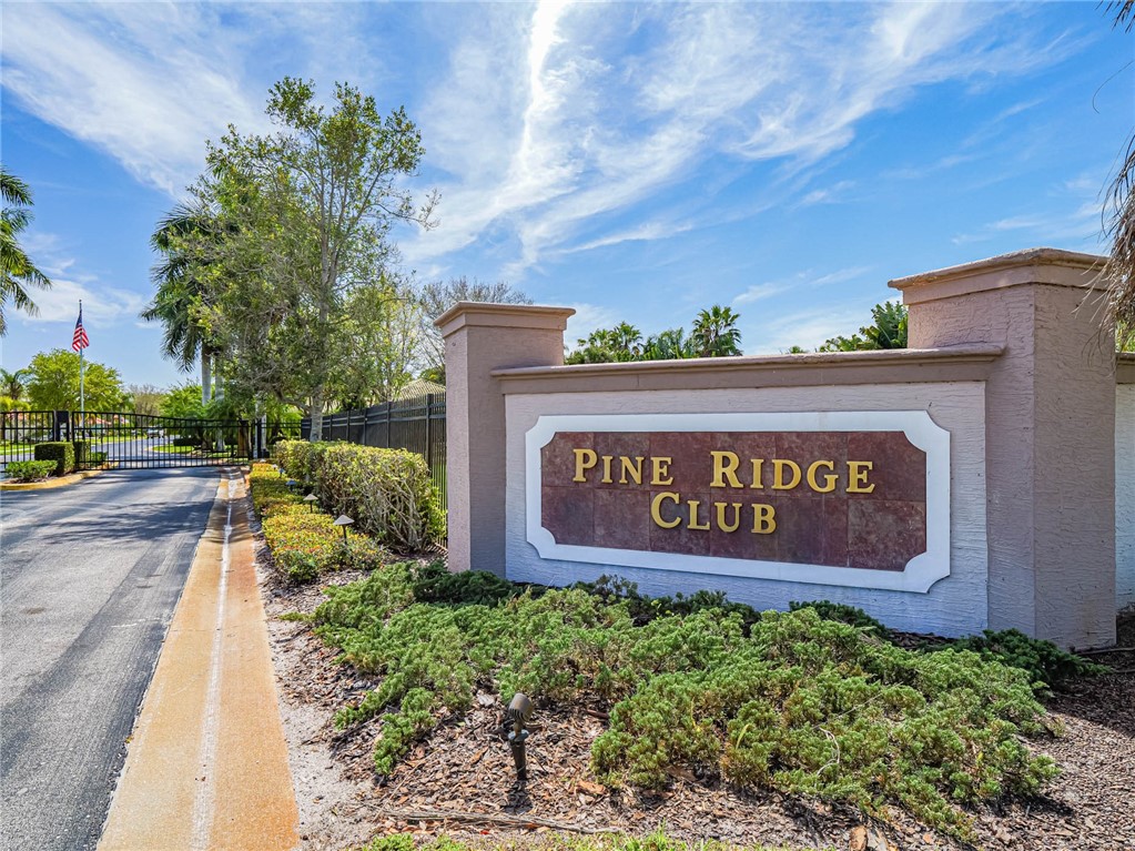 5824 Pine Ridge Circle Vero Beach, FL 32967 - Photo 2 of 34 a sign on the side of a building