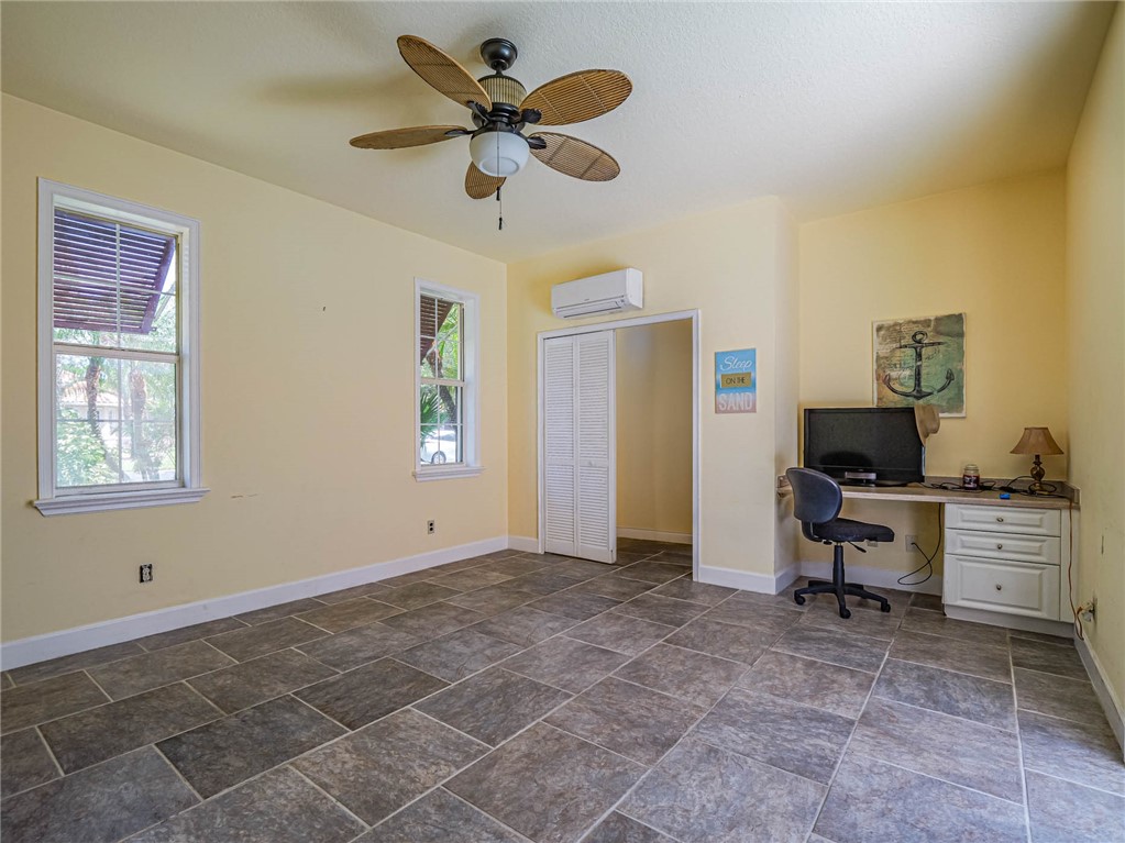 5824 Pine Ridge Circle Vero Beach, FL 32967 - Photo 27 of 34 a view of a workspace with furniture and a window