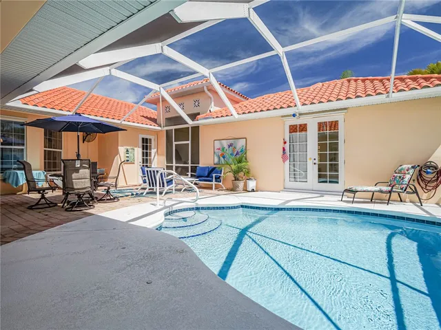 a view of a patio with table and chairs under an umbrella