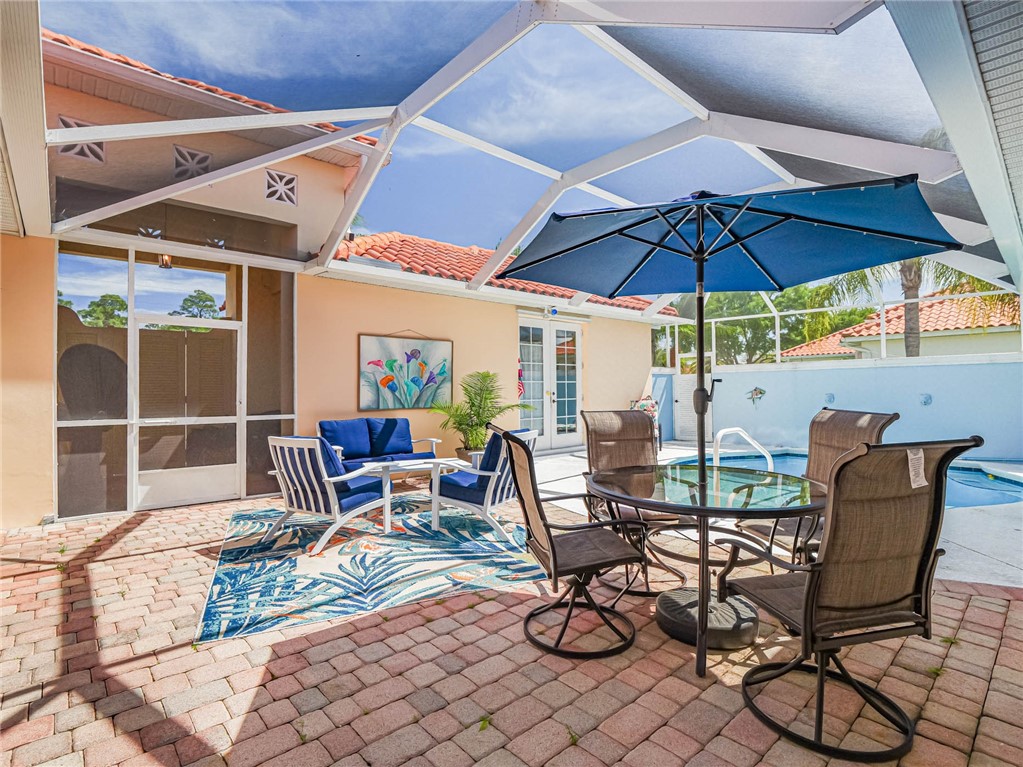 5824 Pine Ridge Circle Vero Beach, FL 32967 - Photo 30 of 34 a view of chair and tables in the patio