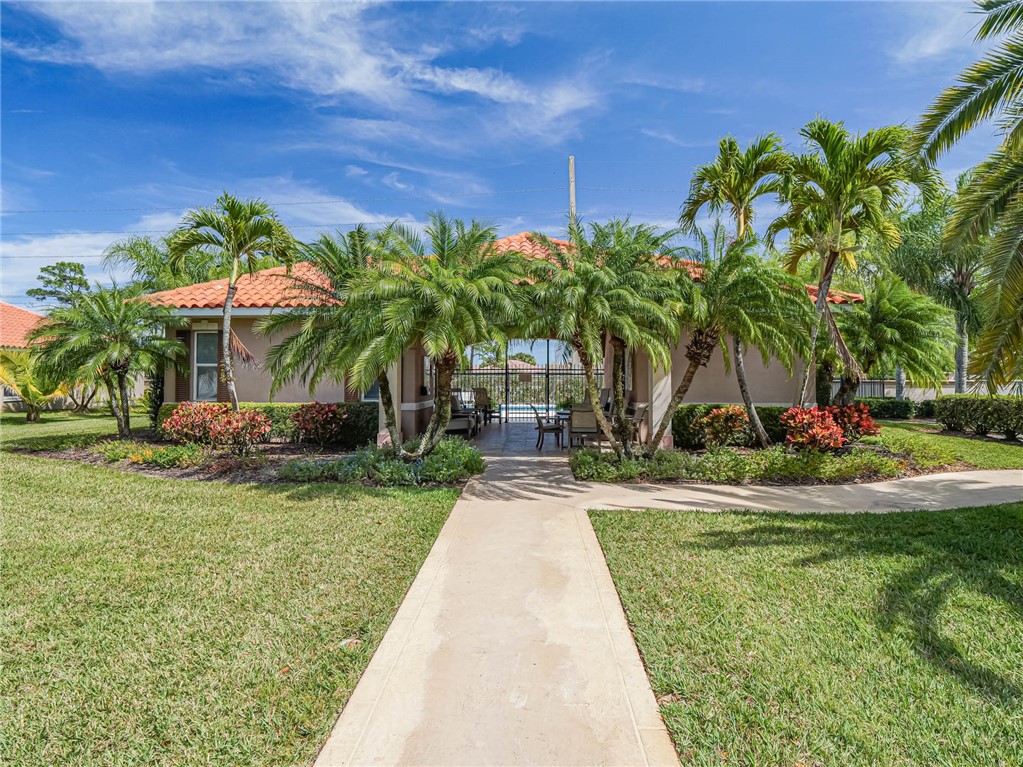 5824 Pine Ridge Circle Vero Beach, FL 32967 - Photo 32 of 34 a front view of a house with garden