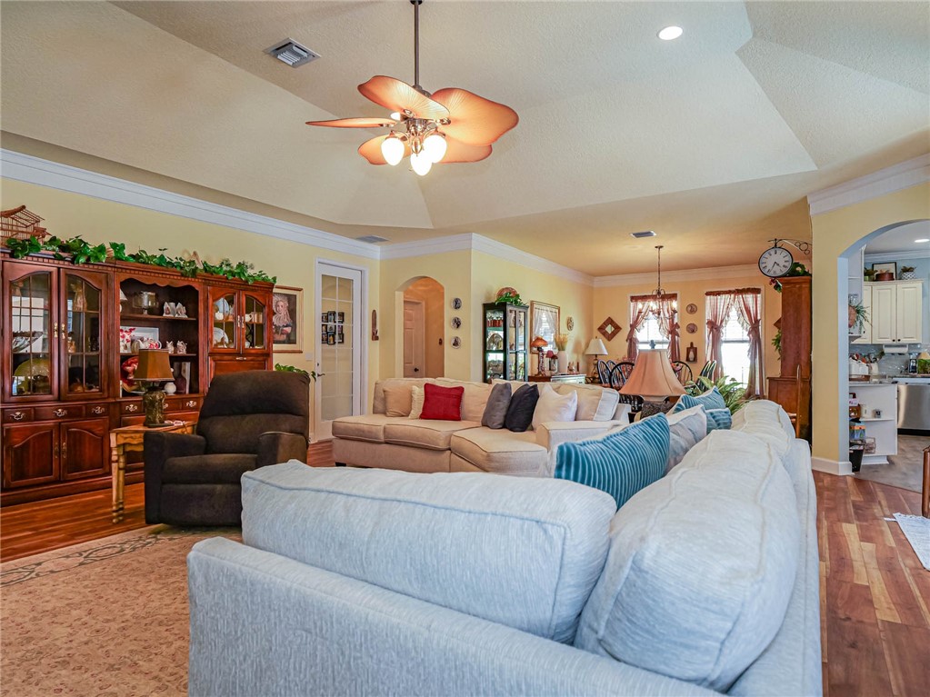 5824 Pine Ridge Circle Vero Beach, FL 32967 - Photo 5 of 34 a living room with fireplace furniture and a chandelier