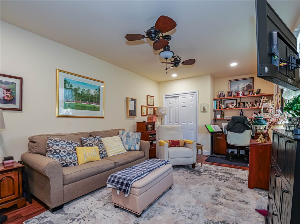 5824 Pine Ridge Circle Vero Beach, FL 32967 - Photo 7 of 34 a living room with furniture and a chandelier