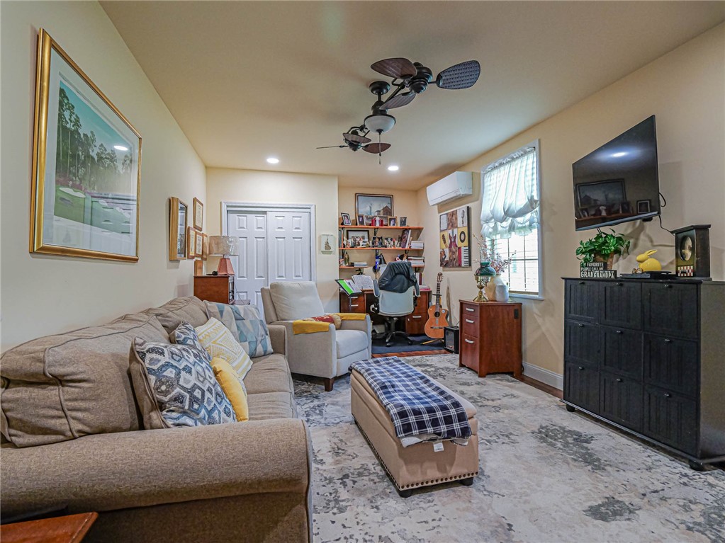5824 Pine Ridge Circle Vero Beach, FL 32967 - Photo 8 of 34 a living room with furniture and a flat screen tv