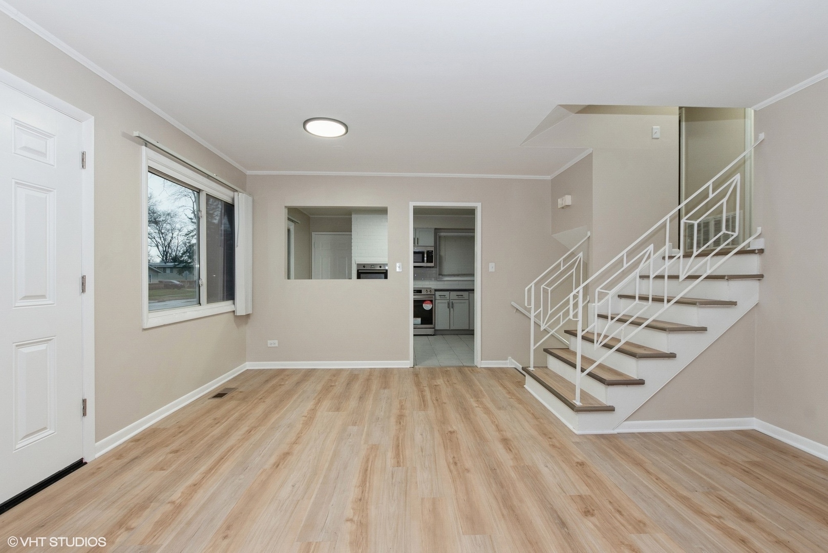 363 Winnebago Street Park Forest, IL 60466 - Photo 2 of 14 a view of an empty room with wooden floor and a window
