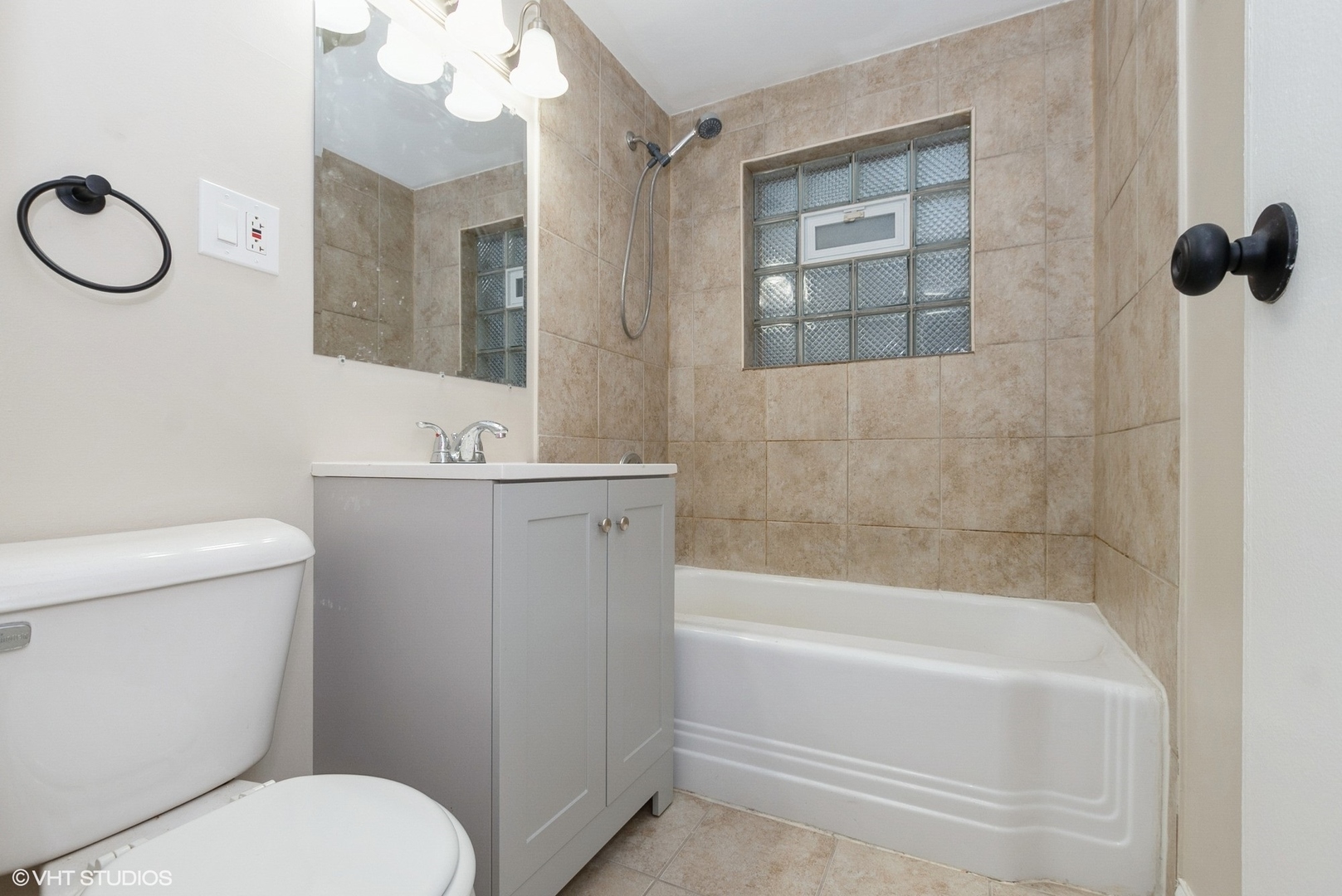 363 Winnebago Street Park Forest, IL 60466 - Photo 10 of 14 a bathroom with a sink a toilet a mirror and shower