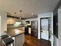 a kitchen with refrigerator and microwave