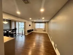 a view of a room with furniture and wooden floor