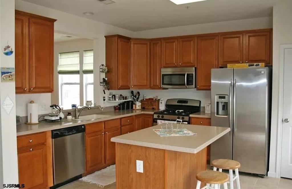 248 Mallard Lane, Unit 248 Egg Harbor Township, NJ 08234 - Photo 3 of 19 a kitchen with a sink a stove a refrigerator and cabinets