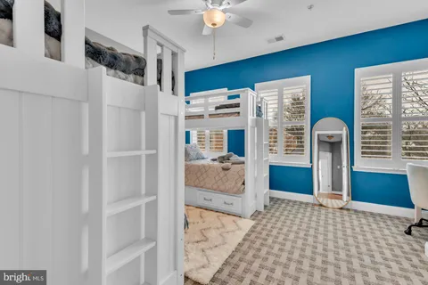 a bathroom with a granite countertop sink a toilet a mirror a bathtub and shower