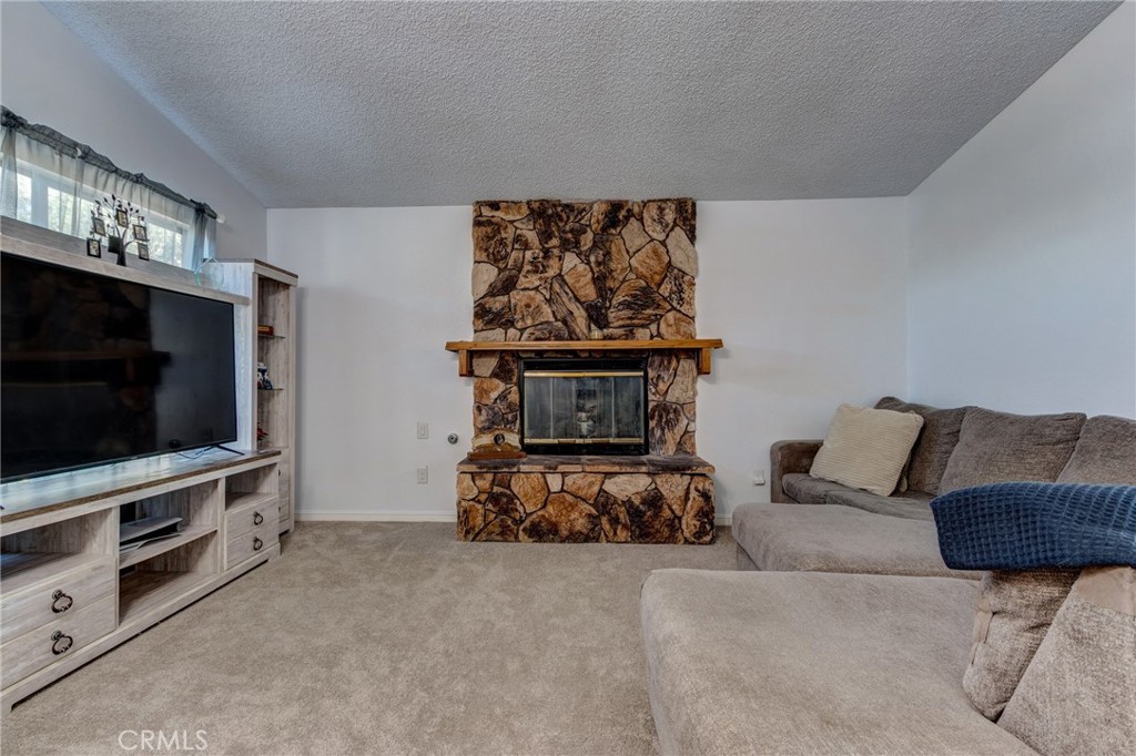 26489 Bluewater Road Helendale, CA 92342 - Photo 11 of 62 a living room with furniture and a flat screen tv